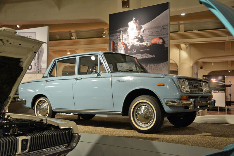 Toyota Corona (1966) Roper steam carriage (1865), Ford 999 (1902), Holsman Runabout (1903), Scripps-Booth Rocket (1913), Detroit-Electric Model 47 (1914), Brewster Town Landaulet (1915), Chevrolet Royal Mail (1915), Woods Dual-Power (1916), Chrysler B-70 (1924), Essex Coach (1924), Ford Flivver (1926), Blue Bird school bus (1927), Lincoln Zephyr (1936), Lincoln Bubbletop (1950), Crosley Hotshot (1951), Chrysler 300-B (1956), Cornell-Liberty Safety Car (1957), Ford Mustang I concept (1962), Buick Riviera (1963), Chrysler turbine car (1963), Ford Mustang (1965), Toyota Corona (1966), Ford Mark IV (1967), Mercury Cougar (1968), Lincoln presidential limousine (1972), Chrysler Newport (1973), Dodge Omni (1978), Comuta-Car (1980), Ford Escort (1981), Plymouth Voyager (1984), Ford Taurus (1986), General Motors EV1 (1997), Toyota Prius (1997), Ford Focus Electric (2009)