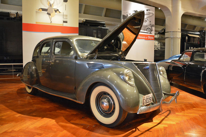 Lincoln Zephyr (1936) Roper steam carriage (1865), Ford 999 (1902), Holsman Runabout (1903), Scripps-Booth Rocket (1913), Detroit-Electric Model 47 (1914), Brewster Town Landaulet (1915), Chevrolet Royal Mail (1915), Woods Dual-Power (1916), Chrysler B-70 (1924), Essex Coach (1924), Ford Flivver (1926), Blue Bird school bus (1927), Lincoln Zephyr (1936), Lincoln Bubbletop (1950), Crosley Hotshot (1951), Chrysler 300-B (1956), Cornell-Liberty Safety Car (1957), Ford Mustang I concept (1962), Buick Riviera (1963), Chrysler turbine car (1963), Ford Mustang (1965), Toyota Corona (1966), Ford Mark IV (1967), Mercury Cougar (1968), Lincoln presidential limousine (1972), Chrysler Newport (1973), Dodge Omni (1978), Comuta-Car (1980), Ford Escort (1981), Plymouth Voyager (1984), Ford Taurus (1986), General Motors EV1 (1997), Toyota Prius (1997), Ford Focus Electric (2009)