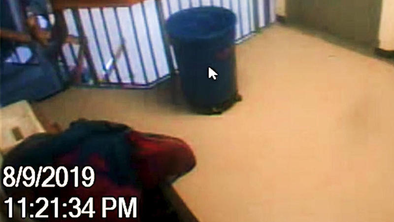 The Epstein jail video, Experts question investigators' interpretation of orange shape moving up the stairs., The "missing minute." , At 12:05:48 a.m., an unidentified individual passes through the SHU., Were there other cameras recording?