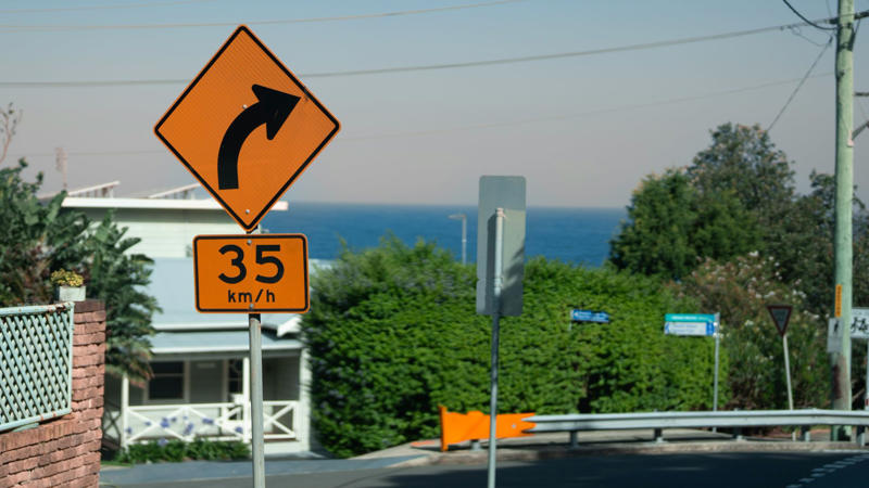 Still Road-Ready—Or Rusty Behind the Wheel?, Q: What does a flashing red traffic light mean?, Q: When are you allowed to pass another vehicle on the right?, A: When the car ahead is turning left, A: Stop completely, regardless of your direction, A: 0.08%, Q: When should you turn your headlights on?, A: At night or in poor visibility, A: No passing in either direction, Q: When merging onto a freeway, who has the right of way?, A: Vehicles already on the freeway, Q: What should you do if your vehicle starts to hydroplane?, A: Ease off the gas and steer straight, Q: What is the hand signal for a left turn?, A: Left arm extended straight out