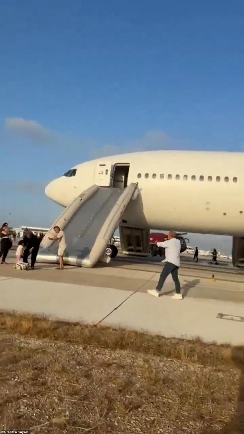 Passengers flee jet after it bursts into flames