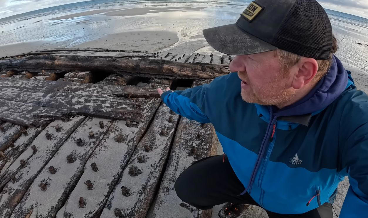 A Shipwreck That Spoke Volumes, Storms Reshape The Sanday Coastline, Unusual Timbers Revealed By The Tide, Discovery Credited To A Local Schoolboy, Discovery Credited To A Local Schoolboy (Cont.), Islanders Mobilize To Recover The Remains, Timbers Were Hauled To Safety By Hand And Tractor, Dendrochronology Pinpoints The Era, Dendrochronology Pinpoints The Era (Cont.), Wessex Archaeology Takes The Lead On Study, Microscopic Grain Patterns Support Naval Origin, Archival Clues Narrow The Field To HMS Hind, Archival Clues Narrow The Field To HMS Hind (Cont.), A War Frigate Built For Empire, A War Frigate Built For The Empire (Cont.), She Crossed Oceans Under The Union Jack, A Whaling Vessel Venturing To The North, The Crew Faced Ice, Isolation, And Peril, March 1788 Marks The End, All 56 Sailors Survived The Ordeal, Lopness Bay Became A Silent Tomb, Folklore Preserved Fragments Of The Tale, Funding Secured For Long-Term Study, Funding Secured For Long-Term Study (Cont.), The Community Leads Its Own Maritime Revival