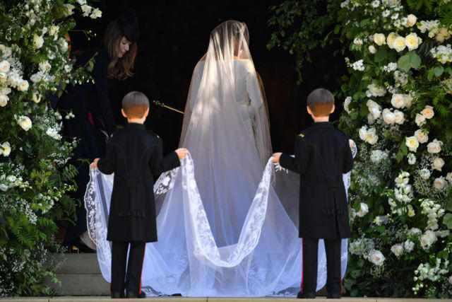 It took 3,900 hours of work by 50 people., Dressmakers had to wash their hands every 30 minutes while making Meghan's 16-foot-veil., Meghan's wedding-day tiara was the last royal tiara she ever wore., The dress featured a hidden, sentimental "something blue.", Meghan's second wedding dress was a Stella McCartney halter gown.