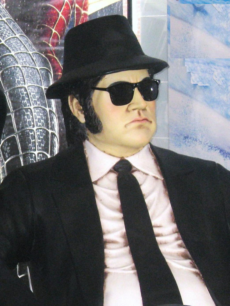 1. Ray-Ban Aviators in Top Gun, 2. John Lennon's Signature Circular Shades, 3. Elton John's Flamboyant On-Stage Specs, 4. Audrey Hepburn's Oversized, Window-shopping Shades, 5. Jackie Onassis: America's Coolest First Lady, 6. Lawrence Fishburn's Matrix Clip-on Look, 7. The Blues Brothers' Ray-Ban Wayfarers, 8. Madonna's Lives in a Material, Cat-eye World, 9. Andy Warhol's Chunky Black Frames, 10. Kurt Cobain's White "Clout Goggles", 11. Cyclops' Futuristic and Highly Necessary Visor, 12. Michael Jackson's Trademark Tour Aviators, 13. Bono's Tinted Rock Star Wrap-arounds, 14. James Dean's Rebellious, Rounded Sunglasses, 15. The Men in Black's Simple Black Shades