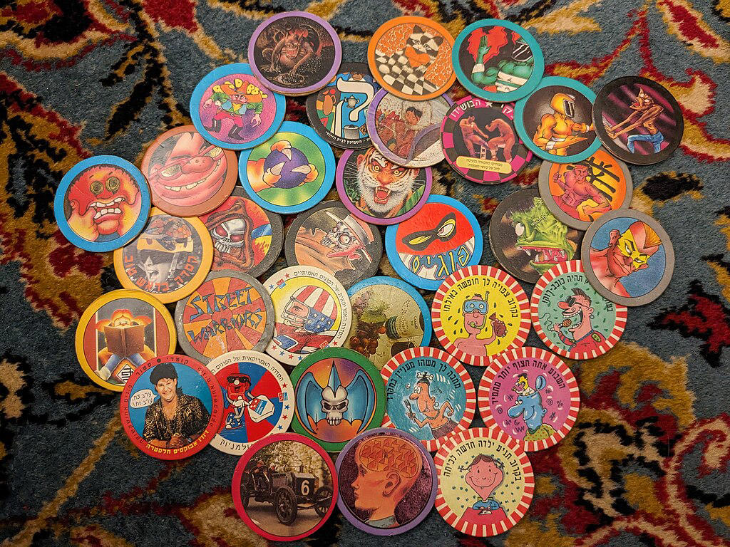 1990s Pogs And Slammers Retro Collectibles That Are Still Loved Today, Original 1980s My Little Pony Toys, 1977 Kenner Star Wars Action Figures, Vintage Tamagotchi Virtual Pets, Classic Rubik’s Cube Puzzle, 1990s Polly Pocket Compacts, Nintendo Game Boy Handheld Console, 1984 Transformers G1 Figures, Beanie Babies By Ty Inc., 1982 Masters Of The Universe Toys, Original Cabbage Patch Kids Dolls, 1990s Pogs And Slammers, Atari 2600 Video Game System, Lisa Frank Stationery Sets, Garbage Pail Kids Trading Cards, 1970s Evel Knievel Stunt Cycle