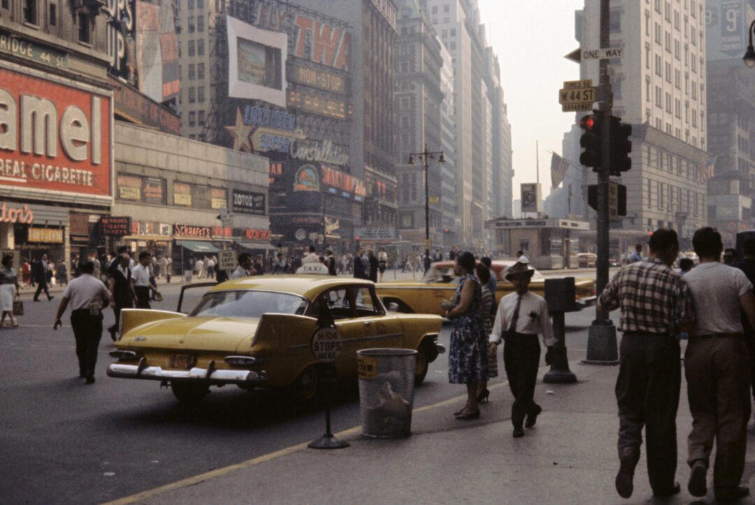 10. Times Square (1959) 1. Boys Setting Up Their Train Model (1946), 2. Dangerous Curves (1949), 3. Before Prom (1967), 4. Going for a Ride in the Convertible (1957), 5. Enjoying a Day at the Public Pool (1960s), 6. Mespelbrunn Castle in Bavaria, Germany, 7. Diving Contest in Palm Beach, Florida (1959), 8. Waiting on a Prom Date (1950s), 9. A Husband’s Portrait of His Wife (1954), 10. Times Square (1959), 11. Little Girl Fishing on the North Shore of Oahu (1960), 12. Couple on Vacation in Florida (1950s), 13. A Baker and His Bread (1950s), 14. Kids Posing by Their Family Vehicle (1966), 15. Brothers Playing in the Snow (1963), 16. Dogs Like Rides Too (1962), 17. Orphan Children from Mooseheart, Illinois (1948), 18. Stopping at Texaco on a Road Trip (1958), 19. Toddler Walking Around in Flowers (1954), 20. Boys on a Camping Trip (1965), 21. Saying Goodbye to Grandma (1950), 22. Picnic in France (1969), 23. A Night at the Bar (1950s), 24. Typical Teen Party (1978)