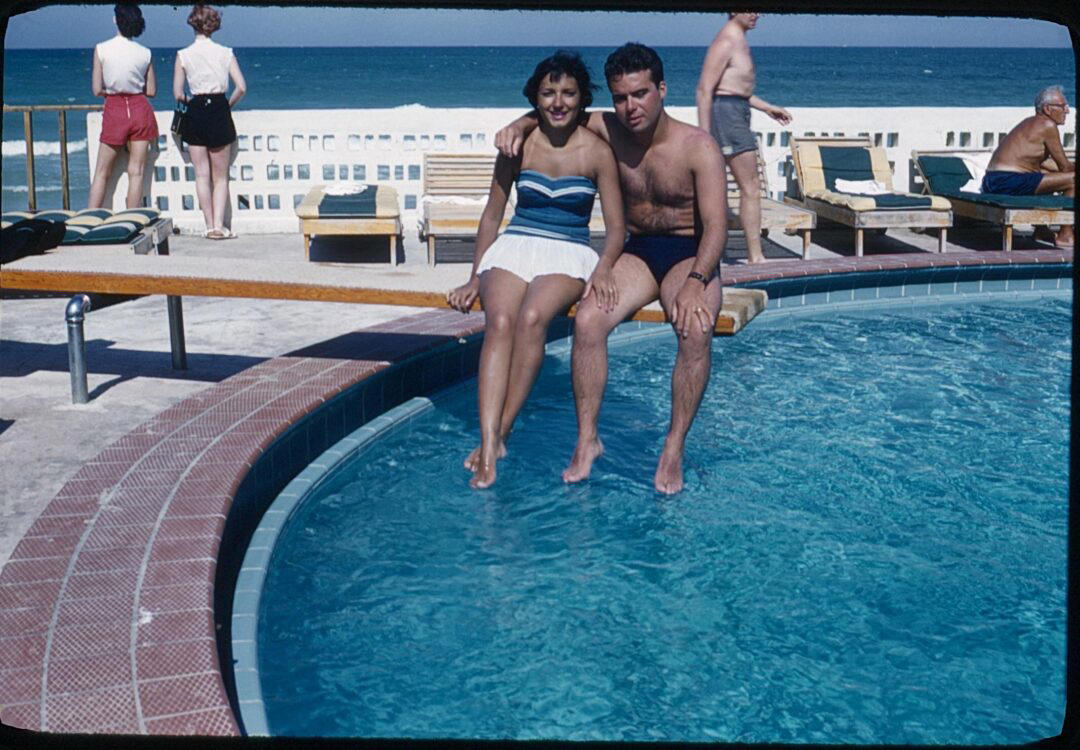 12. Couple on Vacation in Florida (1950s) 1. Boys Setting Up Their Train Model (1946), 2. Dangerous Curves (1949), 3. Before Prom (1967), 4. Going for a Ride in the Convertible (1957), 5. Enjoying a Day at the Public Pool (1960s), 6. Mespelbrunn Castle in Bavaria, Germany, 7. Diving Contest in Palm Beach, Florida (1959), 8. Waiting on a Prom Date (1950s), 9. A Husband’s Portrait of His Wife (1954), 10. Times Square (1959), 11. Little Girl Fishing on the North Shore of Oahu (1960), 12. Couple on Vacation in Florida (1950s), 13. A Baker and His Bread (1950s), 14. Kids Posing by Their Family Vehicle (1966), 15. Brothers Playing in the Snow (1963), 16. Dogs Like Rides Too (1962), 17. Orphan Children from Mooseheart, Illinois (1948), 18. Stopping at Texaco on a Road Trip (1958), 19. Toddler Walking Around in Flowers (1954), 20. Boys on a Camping Trip (1965), 21. Saying Goodbye to Grandma (1950), 22. Picnic in France (1969), 23. A Night at the Bar (1950s), 24. Typical Teen Party (1978)