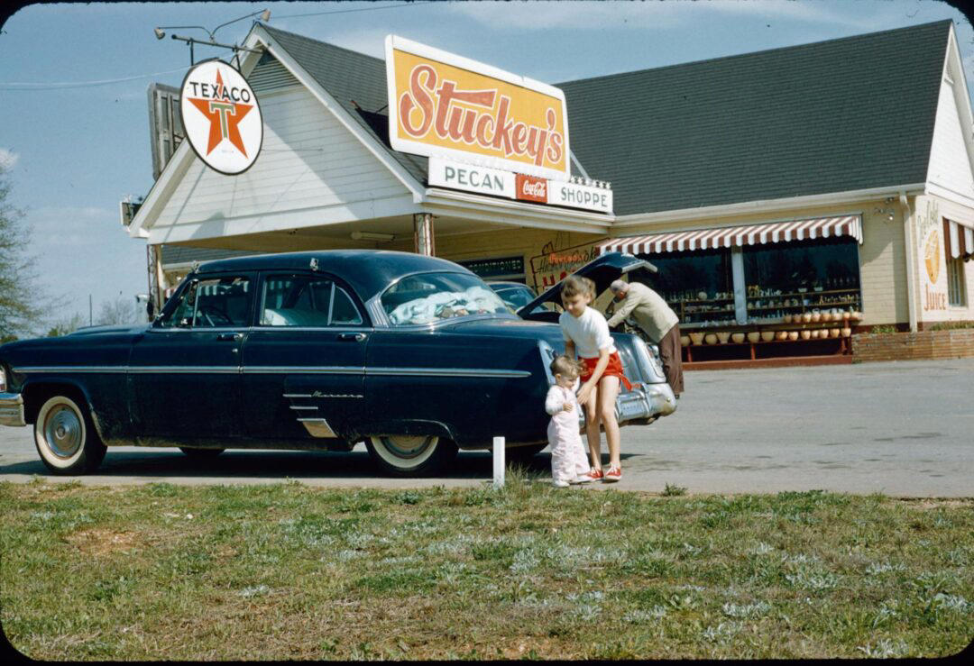 18. Stopping at Texaco on a Road Trip (1958) 1. Boys Setting Up Their Train Model (1946), 2. Dangerous Curves (1949), 3. Before Prom (1967), 4. Going for a Ride in the Convertible (1957), 5. Enjoying a Day at the Public Pool (1960s), 6. Mespelbrunn Castle in Bavaria, Germany, 7. Diving Contest in Palm Beach, Florida (1959), 8. Waiting on a Prom Date (1950s), 9. A Husband’s Portrait of His Wife (1954), 10. Times Square (1959), 11. Little Girl Fishing on the North Shore of Oahu (1960), 12. Couple on Vacation in Florida (1950s), 13. A Baker and His Bread (1950s), 14. Kids Posing by Their Family Vehicle (1966), 15. Brothers Playing in the Snow (1963), 16. Dogs Like Rides Too (1962), 17. Orphan Children from Mooseheart, Illinois (1948), 18. Stopping at Texaco on a Road Trip (1958), 19. Toddler Walking Around in Flowers (1954), 20. Boys on a Camping Trip (1965), 21. Saying Goodbye to Grandma (1950), 22. Picnic in France (1969), 23. A Night at the Bar (1950s), 24. Typical Teen Party (1978)
