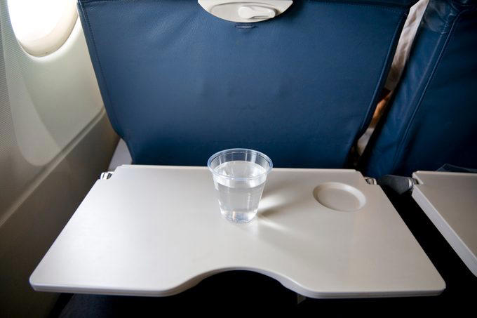 Eat the airplane food, Wear shorts, Drink the plane water, Use the blankets, pillows and mattresses, Go barefoot, Ignore the safety briefing, Sit in the last row, Have more than one alcoholic drink, Book the very last flight of the day, Wear contact lenses the whole flight, Keep the seat reclined during meal service, Put valuables in the seat pocket, Stand in the aisle right after landing, Eat right off the tray table, Assume your checked bag will arrive with you, About the experts, Why trust us, Sources: