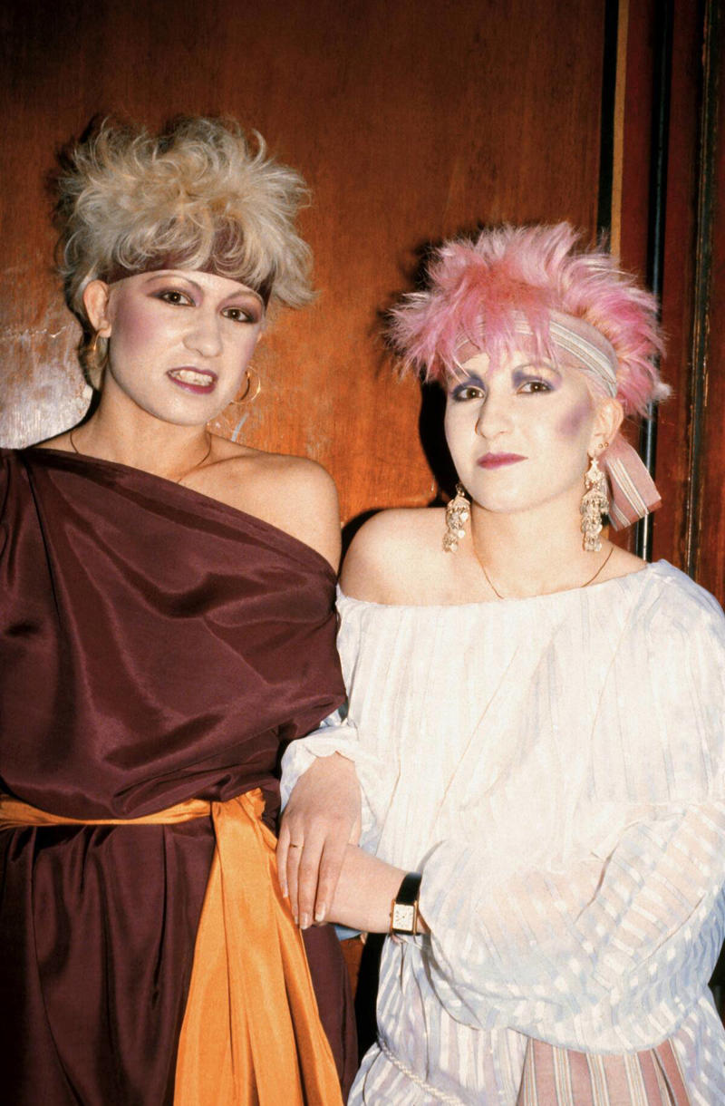 Spiky Women's Hair Vivid Colors, Early Hip Hop Styles, Big Hair, The Post-punk Aesthetic, Turtlenecks, Friends Wearing Matching Outfits, The Jazzercise Look, Shoulder Pads Fit For Linebackers, Jeans And Pants With High Waistlines, Stark Black and White, Short Shorts, Tights And Leotards, Streamlined Athletic Attire, Off-The-Shoulders Tops, Leggings For Aerobics And Style, Spiky Women's Hair, Sequinned Wardrobes, Tassels On Everything, The New York Aesthetic, T-Shirts With Graphics, Gigantic Sunglasses, Big Hair and Pastels, Fashion Gloves, Leather Dresses, Louis Vuitton Jackets And Accessories, Pop Music Went Punk, Cowboy Boots Worn Off The Ranch, Lingerie Worn As Part Of An Outfit, Gawdy Pearls And Jewelry, Real And Faux Feathers, Pouffy and Puffy Accessories, 2-Piece Skirt Suits, Preppy Dressing, Thick Belts With Mini Skirts, Double Blue Denim Outfits, High Top Sneakers And Thick Socks, Acid-Wash Jeans, Fingerless Neon Gloves, Scrunchies, Oversized Earrings In Bright Neon Colors, Ripped Knees On Jeans And Pants, Athletic Tops And Tanks, Knee-High Socks, Ankle Boots, Overalls, Track Suits And Windbreakers