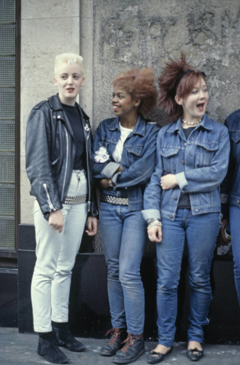 The Post-punk Aesthetic Vivid Colors, Early Hip Hop Styles, Big Hair, The Post-punk Aesthetic, Turtlenecks, Friends Wearing Matching Outfits, The Jazzercise Look, Shoulder Pads Fit For Linebackers, Jeans And Pants With High Waistlines, Stark Black and White, Short Shorts, Tights And Leotards, Streamlined Athletic Attire, Off-The-Shoulders Tops, Leggings For Aerobics And Style, Spiky Women's Hair, Sequinned Wardrobes, Tassels On Everything, The New York Aesthetic, T-Shirts With Graphics, Gigantic Sunglasses, Big Hair and Pastels, Fashion Gloves, Leather Dresses, Louis Vuitton Jackets And Accessories, Pop Music Went Punk, Cowboy Boots Worn Off The Ranch, Lingerie Worn As Part Of An Outfit, Gawdy Pearls And Jewelry, Real And Faux Feathers, Pouffy and Puffy Accessories, 2-Piece Skirt Suits, Preppy Dressing, Thick Belts With Mini Skirts, Double Blue Denim Outfits, High Top Sneakers And Thick Socks, Acid-Wash Jeans, Fingerless Neon Gloves, Scrunchies, Oversized Earrings In Bright Neon Colors, Ripped Knees On Jeans And Pants, Athletic Tops And Tanks, Knee-High Socks, Ankle Boots, Overalls, Track Suits And Windbreakers