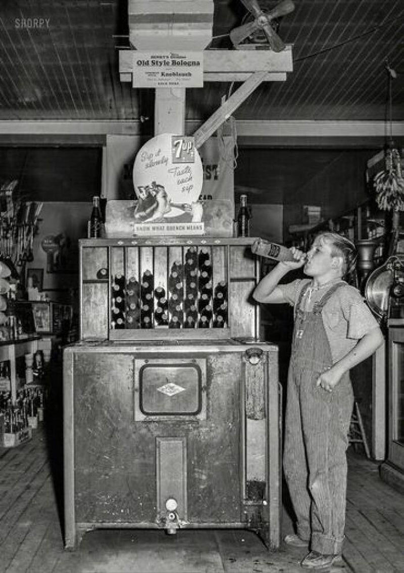 1. Country Store in Oklahoma (1940), 2. Uncle Newt’s Store in Hardin, Tennessee (1945), 3. Woman Looking in a ‘Men Only’ Machine at the Vermont Country Store (1954), 4. Checking Out at a Lynchburg, Tennessee, Store (1972), 5. Double Decker Store in Prospect Hill, North Carolina (1940), 6. McLeary Store, Outside of Salem, Oregon (1959), 7. W.B. Queen, a Fiddler, Playing in a Country Store in Tellico Plains, Tennessee (1941), 8. Soldiers From Fort Benning Playing Pinball in an Alabama Country Store (1941), 9. Putting Ice in the Soft Drink Refrigerator at a Store in Arkansas (1938), 10. General Store in Bigheart, Oklahoma (1908), 11. Grinding Coffee at the General Store in Castolon, Texas (1939), 12. Poolroom at the General Store in Granville County, North Carolina (1940), 13. Manning the Counter (1973), 14. General Store in Moundville, Alabama (1936), 15. Dowd’s Store in Fibre, Michigan (1952), 16. Farm Boy at a General Store Pop Stand in Iowa (1939), 17. Country Store Off a Dirt Road in North Carolina (1939)