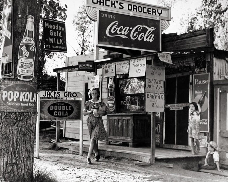 1. Country Store in Oklahoma (1940), 2. Uncle Newt’s Store in Hardin, Tennessee (1945), 3. Woman Looking in a ‘Men Only’ Machine at the Vermont Country Store (1954), 4. Checking Out at a Lynchburg, Tennessee, Store (1972), 5. Double Decker Store in Prospect Hill, North Carolina (1940), 6. McLeary Store, Outside of Salem, Oregon (1959), 7. W.B. Queen, a Fiddler, Playing in a Country Store in Tellico Plains, Tennessee (1941), 8. Soldiers From Fort Benning Playing Pinball in an Alabama Country Store (1941), 9. Putting Ice in the Soft Drink Refrigerator at a Store in Arkansas (1938), 10. General Store in Bigheart, Oklahoma (1908), 11. Grinding Coffee at the General Store in Castolon, Texas (1939), 12. Poolroom at the General Store in Granville County, North Carolina (1940), 13. Manning the Counter (1973), 14. General Store in Moundville, Alabama (1936), 15. Dowd’s Store in Fibre, Michigan (1952), 16. Farm Boy at a General Store Pop Stand in Iowa (1939), 17. Country Store Off a Dirt Road in North Carolina (1939)