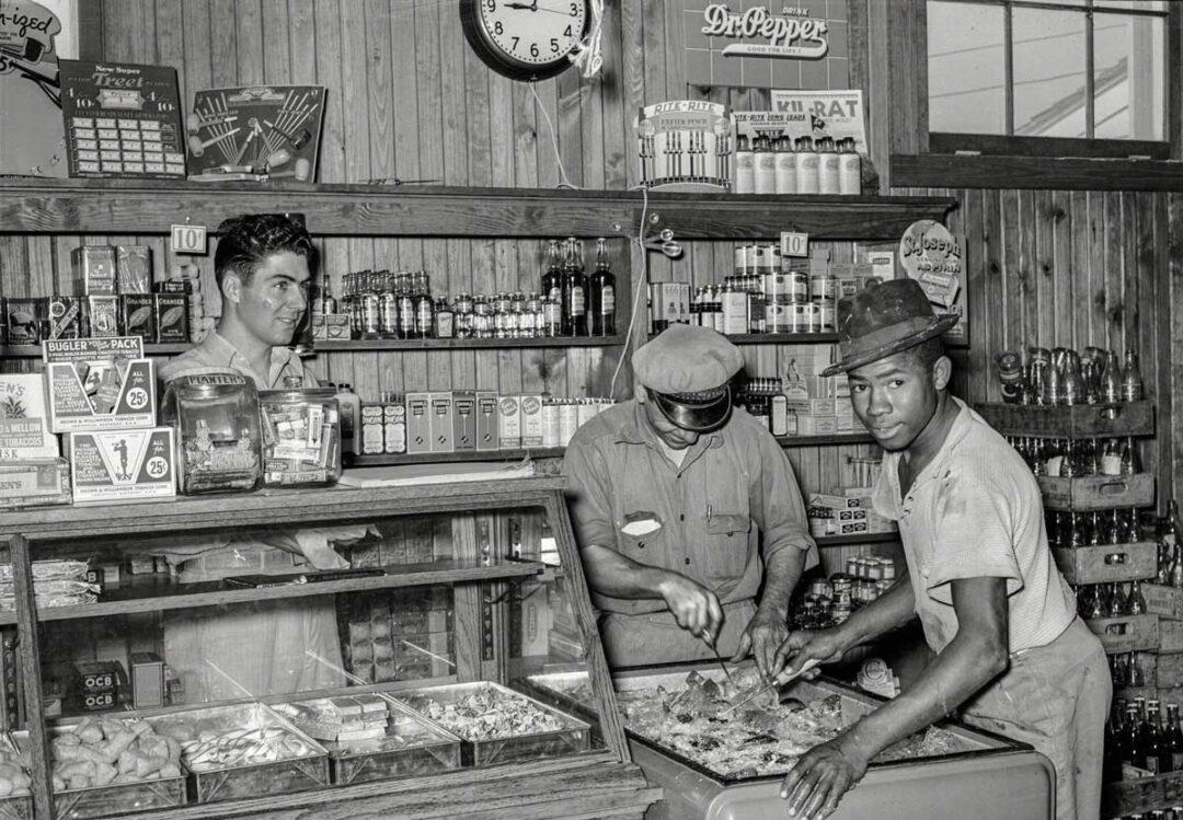 1. Country Store in Oklahoma (1940), 2. Uncle Newt’s Store in Hardin, Tennessee (1945), 3. Woman Looking in a ‘Men Only’ Machine at the Vermont Country Store (1954), 4. Checking Out at a Lynchburg, Tennessee, Store (1972), 5. Double Decker Store in Prospect Hill, North Carolina (1940), 6. McLeary Store, Outside of Salem, Oregon (1959), 7. W.B. Queen, a Fiddler, Playing in a Country Store in Tellico Plains, Tennessee (1941), 8. Soldiers From Fort Benning Playing Pinball in an Alabama Country Store (1941), 9. Putting Ice in the Soft Drink Refrigerator at a Store in Arkansas (1938), 10. General Store in Bigheart, Oklahoma (1908), 11. Grinding Coffee at the General Store in Castolon, Texas (1939), 12. Poolroom at the General Store in Granville County, North Carolina (1940), 13. Manning the Counter (1973), 14. General Store in Moundville, Alabama (1936), 15. Dowd’s Store in Fibre, Michigan (1952), 16. Farm Boy at a General Store Pop Stand in Iowa (1939), 17. Country Store Off a Dirt Road in North Carolina (1939)