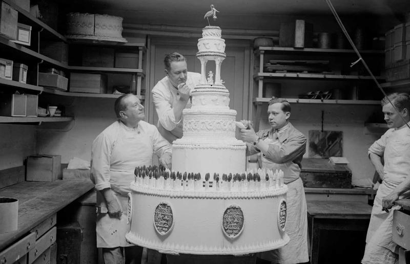 23. Maurice Chevalier's musical cake, 1956, 22. Hank Aaron's baseball tableau cake, 1973, 21. A super-sized sombrero cake, 1933, 20. Pavarotti's artistic cake portrait, 1980, 19. Ingrid Bergman and Charles Boyer's joint birthday cake, 1946, 18. Denise Grey's dual pink birthday cakes, 1985, 17. An elaborate Alice in Wonderland cake, 1932, 16. Shirley Temple's seventh birthday cake, 1936, 15. An extravagant Arc de Triomphe cake, 1983, 14. Glen Campbell's lifelike guitar cake, 1973, 13. A gravity-defying hot air balloon cake, 1933, 12. Elizabeth Taylor's front page cake, 1982, 11. Chuck Berry's rock 'n' roll cake, 1986, 10. Prince Charles' regal 40th birthday cake, 1988, 9. Princess Irene's nautical cake, 1951, 8. An architectural birthday cake, 1981, 7. Queen Charlotte's giant birthday cake, 1930, 6. Franklin D. Roosevelt's monumental birthday cake, 1940, 5. Winston Churchill's 80th birthday cake, 1954, 4. Harry Truman's five-tier birthday cake, 1954, 3. Charlie Chaplin's five-foot birthday cake, 1966, 2. John F. Kennedy's 44th birthday cake, 1961