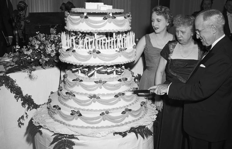 23. Maurice Chevalier's musical cake, 1956, 22. Hank Aaron's baseball tableau cake, 1973, 21. A super-sized sombrero cake, 1933, 20. Pavarotti's artistic cake portrait, 1980, 19. Ingrid Bergman and Charles Boyer's joint birthday cake, 1946, 18. Denise Grey's dual pink birthday cakes, 1985, 17. An elaborate Alice in Wonderland cake, 1932, 16. Shirley Temple's seventh birthday cake, 1936, 15. An extravagant Arc de Triomphe cake, 1983, 14. Glen Campbell's lifelike guitar cake, 1973, 13. A gravity-defying hot air balloon cake, 1933, 12. Elizabeth Taylor's front page cake, 1982, 11. Chuck Berry's rock 'n' roll cake, 1986, 10. Prince Charles' regal 40th birthday cake, 1988, 9. Princess Irene's nautical cake, 1951, 8. An architectural birthday cake, 1981, 7. Queen Charlotte's giant birthday cake, 1930, 6. Franklin D. Roosevelt's monumental birthday cake, 1940, 5. Winston Churchill's 80th birthday cake, 1954, 4. Harry Truman's five-tier birthday cake, 1954, 3. Charlie Chaplin's five-foot birthday cake, 1966, 2. John F. Kennedy's 44th birthday cake, 1961