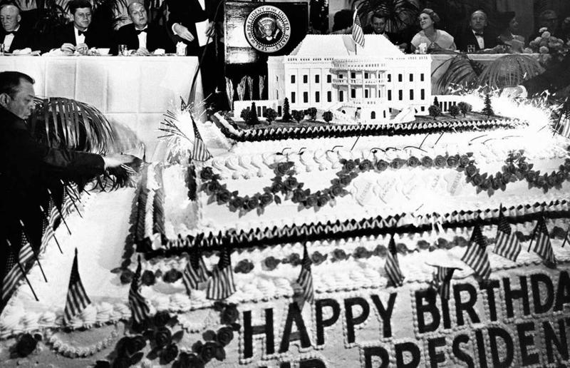 23. Maurice Chevalier's musical cake, 1956, 22. Hank Aaron's baseball tableau cake, 1973, 21. A super-sized sombrero cake, 1933, 20. Pavarotti's artistic cake portrait, 1980, 19. Ingrid Bergman and Charles Boyer's joint birthday cake, 1946, 18. Denise Grey's dual pink birthday cakes, 1985, 17. An elaborate Alice in Wonderland cake, 1932, 16. Shirley Temple's seventh birthday cake, 1936, 15. An extravagant Arc de Triomphe cake, 1983, 14. Glen Campbell's lifelike guitar cake, 1973, 13. A gravity-defying hot air balloon cake, 1933, 12. Elizabeth Taylor's front page cake, 1982, 11. Chuck Berry's rock 'n' roll cake, 1986, 10. Prince Charles' regal 40th birthday cake, 1988, 9. Princess Irene's nautical cake, 1951, 8. An architectural birthday cake, 1981, 7. Queen Charlotte's giant birthday cake, 1930, 6. Franklin D. Roosevelt's monumental birthday cake, 1940, 5. Winston Churchill's 80th birthday cake, 1954, 4. Harry Truman's five-tier birthday cake, 1954, 3. Charlie Chaplin's five-foot birthday cake, 1966, 2. John F. Kennedy's 44th birthday cake, 1961