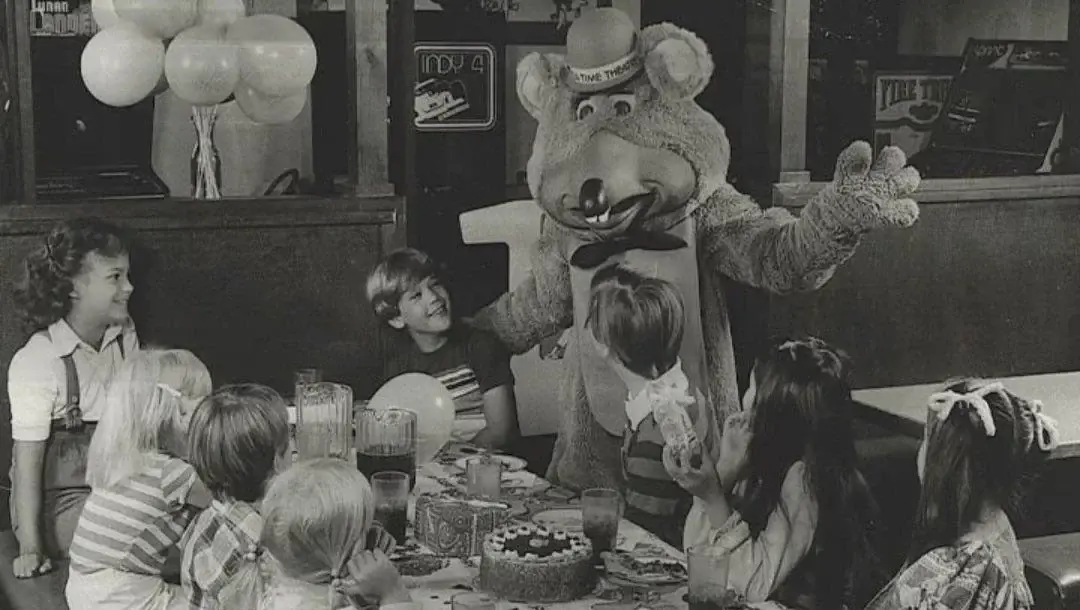 1. Core Memories in the Making, 2. Fresh Pizza Delivered By Chuck Himself? Talk About Birthday Goals, 2. ‘Looking Tough on My 6th Birthday at Chuck E. Cheese in 1996’, 4. Admittedly, Chuck Looked a Bit Creepy at Times, 5. Bet He Remembers the Rage to This Day: ‘The Exact Moment a Random Kid Blew Out My Candles at Chuck E. Cheese in 1991’, 6. A Crown Fit for a [Small] Queen, 7. ‘My Chuck E. Cheese Birthday Party, 1986’, 8. Enjoying Some Pizza While Watching the Animatronic Band, 9. ‘Birthday Party at the Very First Chuck E. Cheese in the Old Town and Country Village Shopping Center’, 10. ‘Fun Birthday Party at Chuck E. Cheese, Late ’80s’, 11. Grown Up Parties Welcome, Too!, 12. No Birthday Was Complete Before All the Gifts Were Opened, 13. You Don’t Say: ‘Me in 1987 With a Creepy-Looking Chuck E Cheese’, 14. ‘At Chuck E. Cheese Proudly Showing Off My Coins, 1993’, 15. ‘Me at Chuck E. Cheese on My 5th Birthday, July 1982’