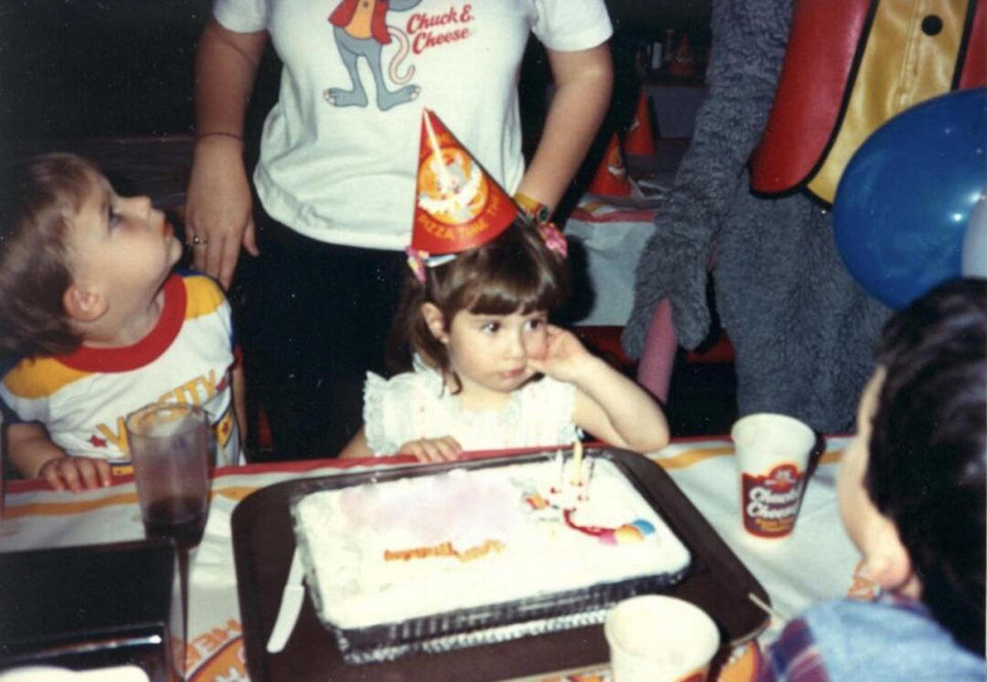1. Core Memories in the Making, 2. Fresh Pizza Delivered By Chuck Himself? Talk About Birthday Goals, 2. ‘Looking Tough on My 6th Birthday at Chuck E. Cheese in 1996’, 4. Admittedly, Chuck Looked a Bit Creepy at Times, 5. Bet He Remembers the Rage to This Day: ‘The Exact Moment a Random Kid Blew Out My Candles at Chuck E. Cheese in 1991’, 6. A Crown Fit for a [Small] Queen, 7. ‘My Chuck E. Cheese Birthday Party, 1986’, 8. Enjoying Some Pizza While Watching the Animatronic Band, 9. ‘Birthday Party at the Very First Chuck E. Cheese in the Old Town and Country Village Shopping Center’, 10. ‘Fun Birthday Party at Chuck E. Cheese, Late ’80s’, 11. Grown Up Parties Welcome, Too!, 12. No Birthday Was Complete Before All the Gifts Were Opened, 13. You Don’t Say: ‘Me in 1987 With a Creepy-Looking Chuck E Cheese’, 14. ‘At Chuck E. Cheese Proudly Showing Off My Coins, 1993’, 15. ‘Me at Chuck E. Cheese on My 5th Birthday, July 1982’