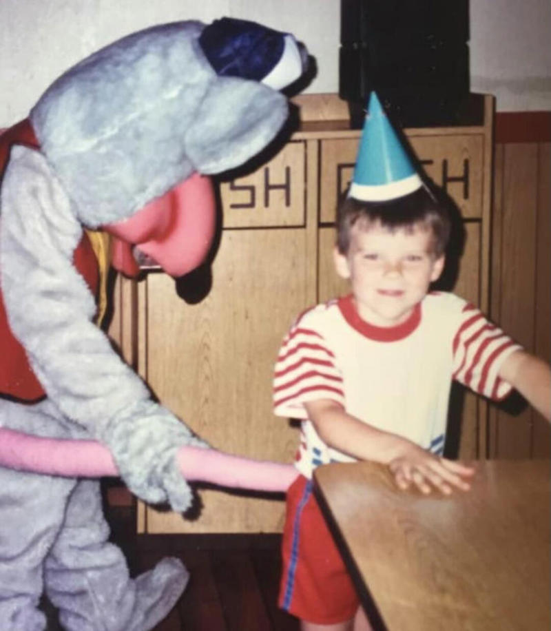 1. Core Memories in the Making, 2. Fresh Pizza Delivered By Chuck Himself? Talk About Birthday Goals, 2. ‘Looking Tough on My 6th Birthday at Chuck E. Cheese in 1996’, 4. Admittedly, Chuck Looked a Bit Creepy at Times, 5. Bet He Remembers the Rage to This Day: ‘The Exact Moment a Random Kid Blew Out My Candles at Chuck E. Cheese in 1991’, 6. A Crown Fit for a [Small] Queen, 7. ‘My Chuck E. Cheese Birthday Party, 1986’, 8. Enjoying Some Pizza While Watching the Animatronic Band, 9. ‘Birthday Party at the Very First Chuck E. Cheese in the Old Town and Country Village Shopping Center’, 10. ‘Fun Birthday Party at Chuck E. Cheese, Late ’80s’, 11. Grown Up Parties Welcome, Too!, 12. No Birthday Was Complete Before All the Gifts Were Opened, 13. You Don’t Say: ‘Me in 1987 With a Creepy-Looking Chuck E Cheese’, 14. ‘At Chuck E. Cheese Proudly Showing Off My Coins, 1993’, 15. ‘Me at Chuck E. Cheese on My 5th Birthday, July 1982’