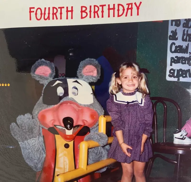 1. Core Memories in the Making, 2. Fresh Pizza Delivered By Chuck Himself? Talk About Birthday Goals, 2. ‘Looking Tough on My 6th Birthday at Chuck E. Cheese in 1996’, 4. Admittedly, Chuck Looked a Bit Creepy at Times, 5. Bet He Remembers the Rage to This Day: ‘The Exact Moment a Random Kid Blew Out My Candles at Chuck E. Cheese in 1991’, 6. A Crown Fit for a [Small] Queen, 7. ‘My Chuck E. Cheese Birthday Party, 1986’, 8. Enjoying Some Pizza While Watching the Animatronic Band, 9. ‘Birthday Party at the Very First Chuck E. Cheese in the Old Town and Country Village Shopping Center’, 10. ‘Fun Birthday Party at Chuck E. Cheese, Late ’80s’, 11. Grown Up Parties Welcome, Too!, 12. No Birthday Was Complete Before All the Gifts Were Opened, 13. You Don’t Say: ‘Me in 1987 With a Creepy-Looking Chuck E Cheese’, 14. ‘At Chuck E. Cheese Proudly Showing Off My Coins, 1993’, 15. ‘Me at Chuck E. Cheese on My 5th Birthday, July 1982’