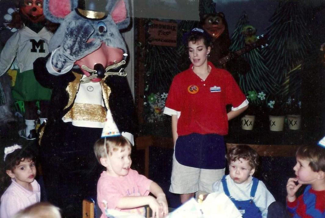 1. Core Memories in the Making, 2. Fresh Pizza Delivered By Chuck Himself? Talk About Birthday Goals, 2. ‘Looking Tough on My 6th Birthday at Chuck E. Cheese in 1996’, 4. Admittedly, Chuck Looked a Bit Creepy at Times, 5. Bet He Remembers the Rage to This Day: ‘The Exact Moment a Random Kid Blew Out My Candles at Chuck E. Cheese in 1991’, 6. A Crown Fit for a [Small] Queen, 7. ‘My Chuck E. Cheese Birthday Party, 1986’, 8. Enjoying Some Pizza While Watching the Animatronic Band, 9. ‘Birthday Party at the Very First Chuck E. Cheese in the Old Town and Country Village Shopping Center’, 10. ‘Fun Birthday Party at Chuck E. Cheese, Late ’80s’, 11. Grown Up Parties Welcome, Too!, 12. No Birthday Was Complete Before All the Gifts Were Opened, 13. You Don’t Say: ‘Me in 1987 With a Creepy-Looking Chuck E Cheese’, 14. ‘At Chuck E. Cheese Proudly Showing Off My Coins, 1993’, 15. ‘Me at Chuck E. Cheese on My 5th Birthday, July 1982’