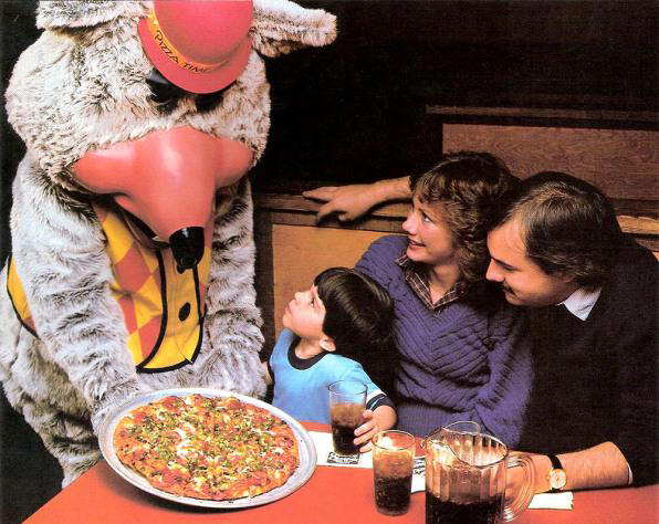 1. Core Memories in the Making, 2. Fresh Pizza Delivered By Chuck Himself? Talk About Birthday Goals, 2. ‘Looking Tough on My 6th Birthday at Chuck E. Cheese in 1996’, 4. Admittedly, Chuck Looked a Bit Creepy at Times, 5. Bet He Remembers the Rage to This Day: ‘The Exact Moment a Random Kid Blew Out My Candles at Chuck E. Cheese in 1991’, 6. A Crown Fit for a [Small] Queen, 7. ‘My Chuck E. Cheese Birthday Party, 1986’, 8. Enjoying Some Pizza While Watching the Animatronic Band, 9. ‘Birthday Party at the Very First Chuck E. Cheese in the Old Town and Country Village Shopping Center’, 10. ‘Fun Birthday Party at Chuck E. Cheese, Late ’80s’, 11. Grown Up Parties Welcome, Too!, 12. No Birthday Was Complete Before All the Gifts Were Opened, 13. You Don’t Say: ‘Me in 1987 With a Creepy-Looking Chuck E Cheese’, 14. ‘At Chuck E. Cheese Proudly Showing Off My Coins, 1993’, 15. ‘Me at Chuck E. Cheese on My 5th Birthday, July 1982’