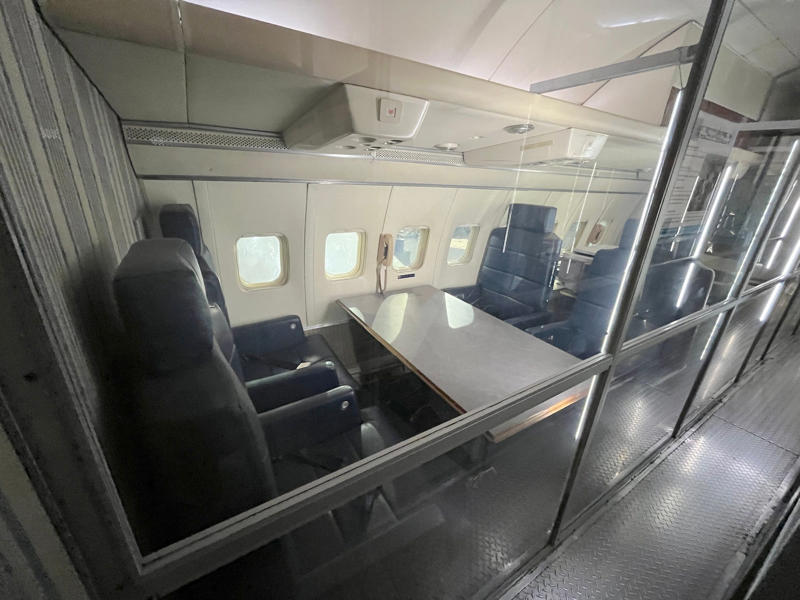 Additional conference areas provided more seating for staff, Secret Service members, and VIPs. Two phones were located behind the flight deck., An equipment storage space featured a first aid kit and firearms., Next, I walked by the plane's communication facility., Meals were prepared in the galley., The presidential stateroom was located down a long hallway., The president's spacious quarters featured a desk, couch, television, and private bathroom., The stateroom came with two phones, each with different purposes., Behind the presidential stateroom, a conference room provided more meeting space.