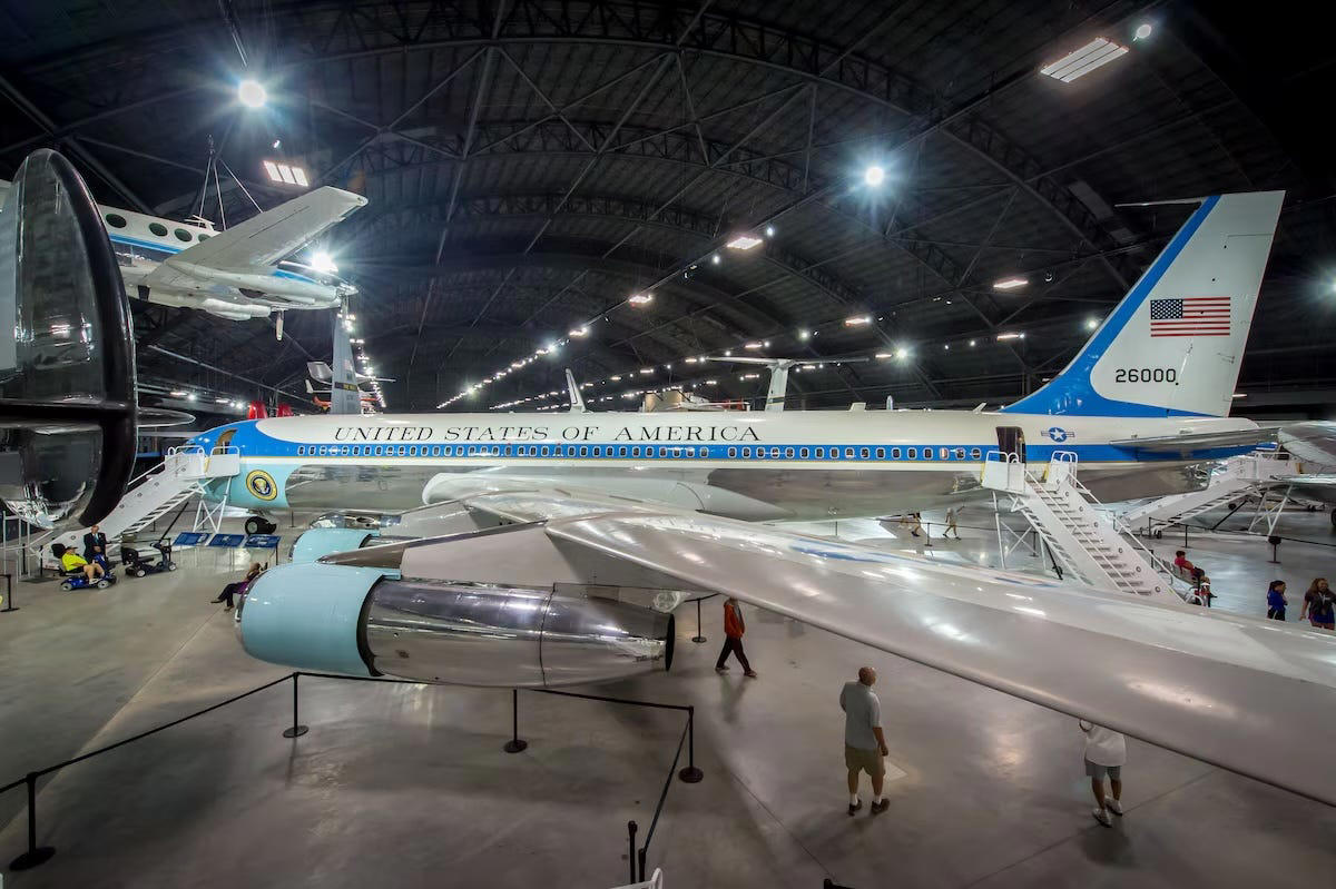 I toured the Air Force One plane that carried 8 presidents and brought JFK's body home from Dallas. Take a look inside. Two phones were located behind the flight deck., An equipment storage space featured a first aid kit and firearms., Next, I walked by the plane's communication facility., Meals were prepared in the galley., The presidential stateroom was located down a long hallway., The president's spacious quarters featured a desk, couch, television, and private bathroom., The stateroom came with two phones, each with different purposes., Behind the presidential stateroom, a conference room provided more meeting space.