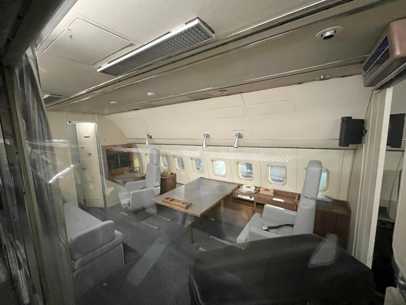 The president's spacious quarters featured a desk, couch, television, and private bathroom. Two phones were located behind the flight deck., An equipment storage space featured a first aid kit and firearms., Next, I walked by the plane's communication facility., Meals were prepared in the galley., The presidential stateroom was located down a long hallway., The president's spacious quarters featured a desk, couch, television, and private bathroom., The stateroom came with two phones, each with different purposes., Behind the presidential stateroom, a conference room provided more meeting space.