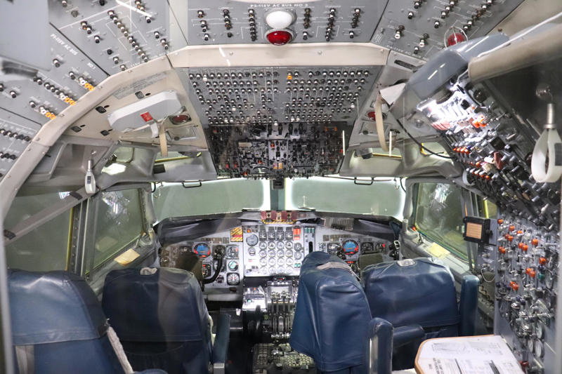 The first stop on my self-guided tour was the cockpit, which featured a four-person crew. Two phones were located behind the flight deck., An equipment storage space featured a first aid kit and firearms., Next, I walked by the plane's communication facility., Meals were prepared in the galley., The presidential stateroom was located down a long hallway., The president's spacious quarters featured a desk, couch, television, and private bathroom., The stateroom came with two phones, each with different purposes., Behind the presidential stateroom, a conference room provided more meeting space.