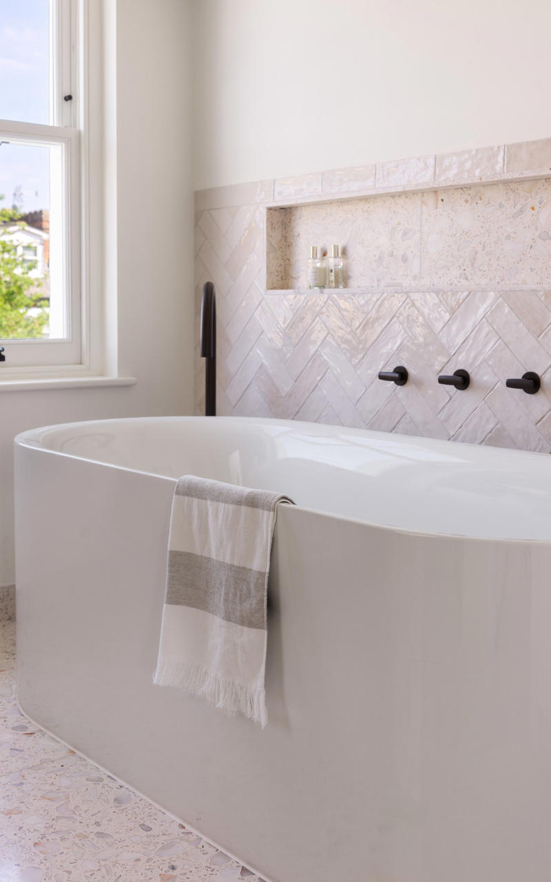 The en-suite, Start with the floor, Nail the layout, Keep it clean and crisp, Get clever with storage, Add interest to a monochrome palette, Light it like a living room, Work with flaws, Kate’s tips for creating a modern bathroom with a timeless touch, Ground your space in natural, earthy hues, Layer in texture for depth and interest, Keep fixtures simple and enduring, Balance organic warmth with clean lines, Anchor your palette, then layer thoughtfully