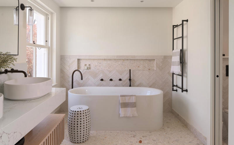 The en-suite, Start with the floor, Nail the layout, Keep it clean and crisp, Get clever with storage, Add interest to a monochrome palette, Light it like a living room, Work with flaws, Kate’s tips for creating a modern bathroom with a timeless touch, Ground your space in natural, earthy hues, Layer in texture for depth and interest, Keep fixtures simple and enduring, Balance organic warmth with clean lines, Anchor your palette, then layer thoughtfully