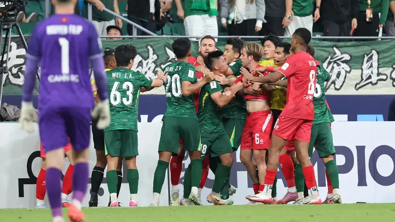 中国とベトナムのサッカー選手が乱闘。, AFCチャンピオンズリーグの試合中に混乱が発生。, 北京国安対ベトナム・ハノイ戦の終盤、乱闘が勃発した。, 両チームの選手が入り乱れての大乱闘。, 時間を無駄にしていた事から口論となり、さらには乱闘へと発展した。, 激しい殴打で状況は緊迫した。, 審判は落ち着きを取り戻そうと奮闘した。, 試合は6分以上中断された。, スタンドから観客がピッチにボトルを投げ入れて抗議した。, 看板の上に倒れる選手もいた。, 意外なことに、審判は誰も退場させなかった。, 緊迫したこの試合は2-2で終了した。