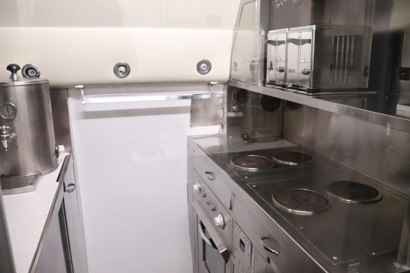 The galley included a toaster, stovetop, oven, and urns for hot water and ice water. The cockpit featured seats for the pilot, copilot, and flight engineer., The radio operator worked out of this room behind the cockpit., Storage areas separated the crew from Eisenhower's presidential workspace., This seating area was used by members of Eisenhower's staff., Eisenhower's presidential stateroom was located toward the back of the plane., The stateroom also featured two couches that could fold down into beds., The most luxurious part of the plane was the president's spacious lavatory.
