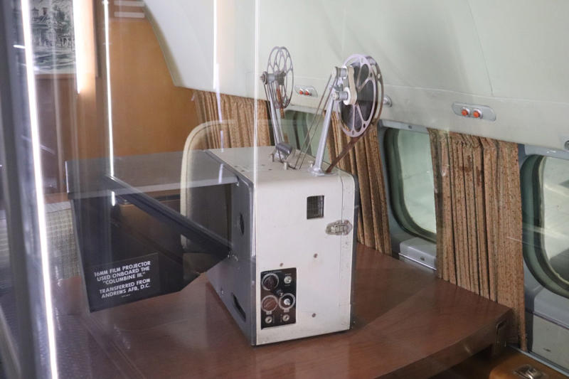 The museum displayed the actual 16-millimeter film projector that Eisenhower used on board the plane. The cockpit featured seats for the pilot, copilot, and flight engineer., The radio operator worked out of this room behind the cockpit., Storage areas separated the crew from Eisenhower's presidential workspace., This seating area was used by members of Eisenhower's staff., Eisenhower's presidential stateroom was located toward the back of the plane., The stateroom also featured two couches that could fold down into beds., The most luxurious part of the plane was the president's spacious lavatory.