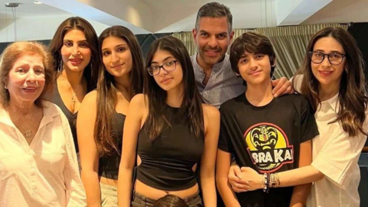 Sunjay Kapoor is seen here surrounded by his extended family, including ex-wife Karisma Kapoor, current wife Priya Sachdev, and all their children. The photograph beautifully reflects love, acceptance, and the shared bond of family.