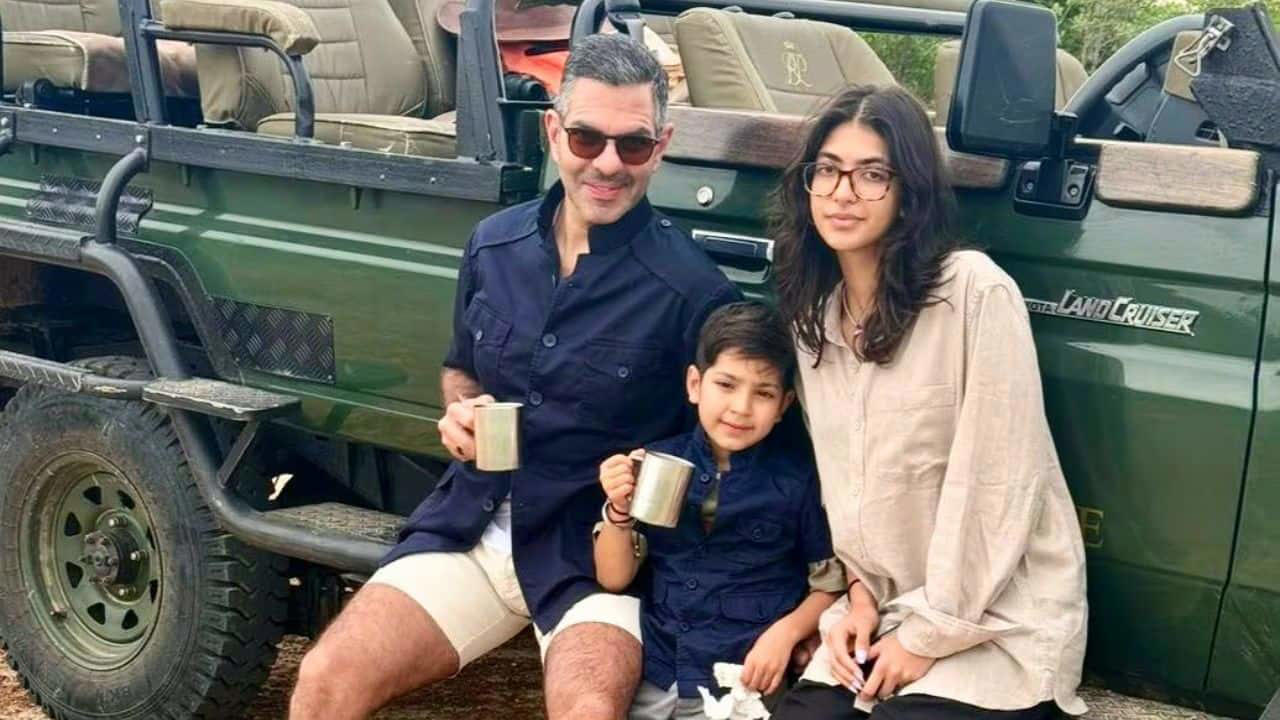 Sunjay Kapur is seen here enjoying a relaxed safari moment with his children, Samaira and Azarias. With mugs in hand and smiles all around, the picture captures a joyful memory of togetherness in nature.