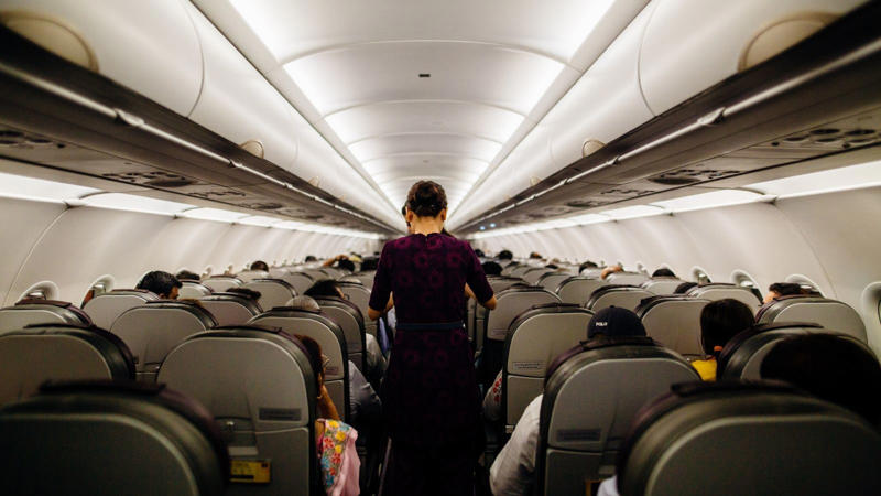 On top of that, the dry cabin air contributes to dehydration, slowing down digestion and allowing gas to accumulate. Add hours of sitting in one position and you have the perfect storm for digestive distress mid-flight. (Image: Canva)