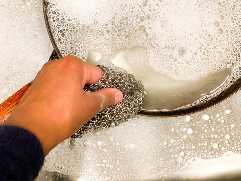 1) Make a DIY pie crust shield., 2) Scrub stubborn pots and pans., 3) Help prevent freezer burn, 5) Clean silverware, 6) De-rust tools., 7) Remove stuck-on grill food., 8) Block drafty windows., 9) Keep matches dry., 10) Protect soap bars for travel.