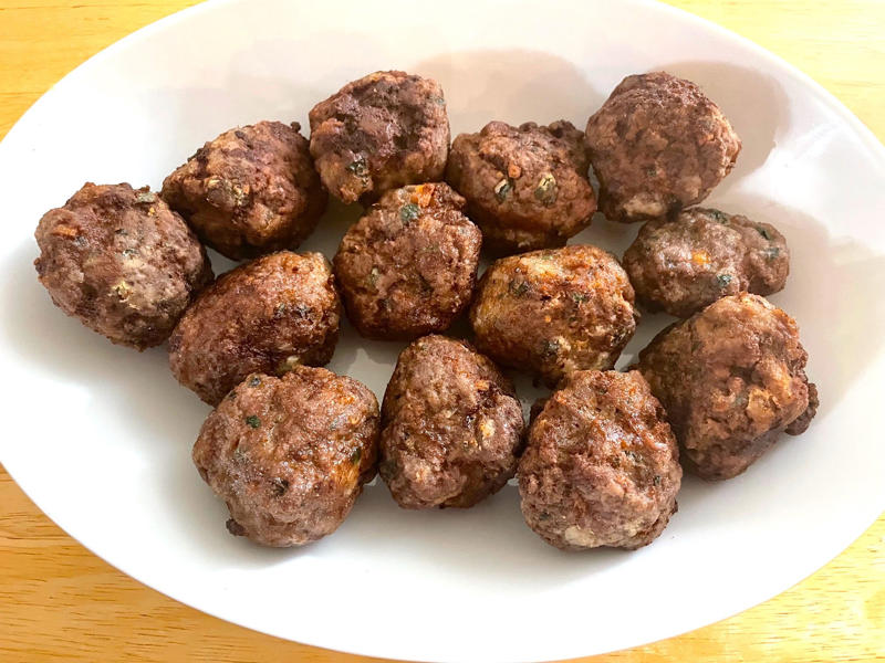 Before making the meatballs, we just need to do some quick prep., Then, mix everything together with your hands., Once your mixture is ready, start shaping the meatballs., Add the meatballs, one by one, into the pan., Use two forks to gently rotate each meatball every two minutes., It will take about 10 minutes to cook the meatballs.