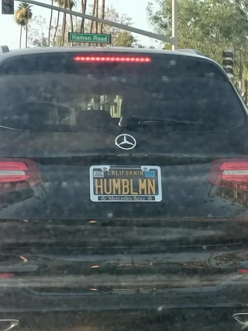 1. Whasaab, 2. Brand confusion, 3. Subauwu, 4. Get a load of this guy, 6. The impala, 7. An awh-sum car, 8. Ur obese, 9. Why be normal, 10. A very Canadian plate, 11. Comedy in one word, 12. Cheeto Jeep, 13. Luxury with a side of humility, 14. Midlife dream or crisis, 15. No problem parking, 16. Meta, 17. Sassy exit, 18. It’s a vibe, 19. License plate therapy session, 20. Purrsonality on wheels, 21. Owning it, 22. Keeping it literal, 23. Priorities on display, 24. Serving royal energy, 25. Weewoo on wheels, 26. Corvette over retirement, 27. Minivan mythology, 28. Big wheels, green dreams, 29. Owning the slow lane, 30. Queen of the mud pits