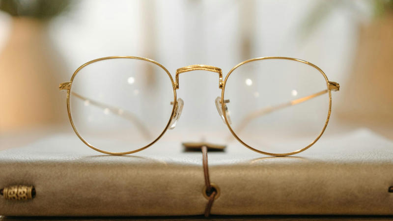 1. Classic Round Frames, 2. Bold Wayfarer Frames, 3. Transparent Frames, 4. Cat-Eye Glasses, 5. Oversized Frames, 6. Aviator Glasses, 7. Geometric Frames, 8. Wooden Frames, 9. Metal Rimless Glasses, 10. Double Bridge Frames, 11. Thick Black Frames, 12. Tortoiseshell Patterns, 13. Sporty Wrap-Around Frames, 14. Semi-Rimless Frames, 15. Gradient Color Frames, 16. Vintage Wire Frames, 17. Asymmetrical Frames, 18. Glow-In-The-Dark Frames, 19. Custom Painted Hand-Decorated Frames, 20. Eco-Friendly Recycled Material Frames