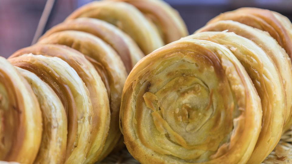 Bolani, Afghanistan, Lavash, Armenia, Damper bread, Australia, Luchi, Bangladesh, Pão de queijo, Brazil, Montreal bagels, Canada, Marraqueta, Chile, Shaobing, China, Pan Cubano, Cuba, Libba, Egypt, Pupusas, El Salvador, Injera, Ethiopia, Baguette, France, Khachapuri, Georgia, Pumpernickel, Germany, Pai bao, Hong Kong, Dökkt rúgbrauð, Iceland, Paratha, India, Roti gambang, Indonesia, Sangak, Iran, Soda bread, Ireland, Challah, Israel, Ciabatta, Italy, Bammy bread, Jamaica, Kare pan, Japan, Taboon bread, Jordan, Roti canai, Malaysia, Ħobż tal-Malti, Malta, Tortillas, Mexico, Khobz kesra, Morocco, Fry bread, Navajo Nation, Tijgerbrood, Netherlands, Rēwena parāoa, New Zealand, Lefse, Norway, Podplomyk, Poland, Broa de milho, Portugal, Karavai, Russia, Pane carasau, Sardinia, Proja, Serbia, Gyeran-ppang, South Korea, Appam, Sri Lanka, Kisra, Sudan and South Sudan, Limpa bread, Sweden, Balep korkun, Tibet, Simit, Turkey, Crumpets, United Kingdom, Biscuits, United States, Non, Uzbekistan, Arepa, Venezuela, Malawach, Yemen