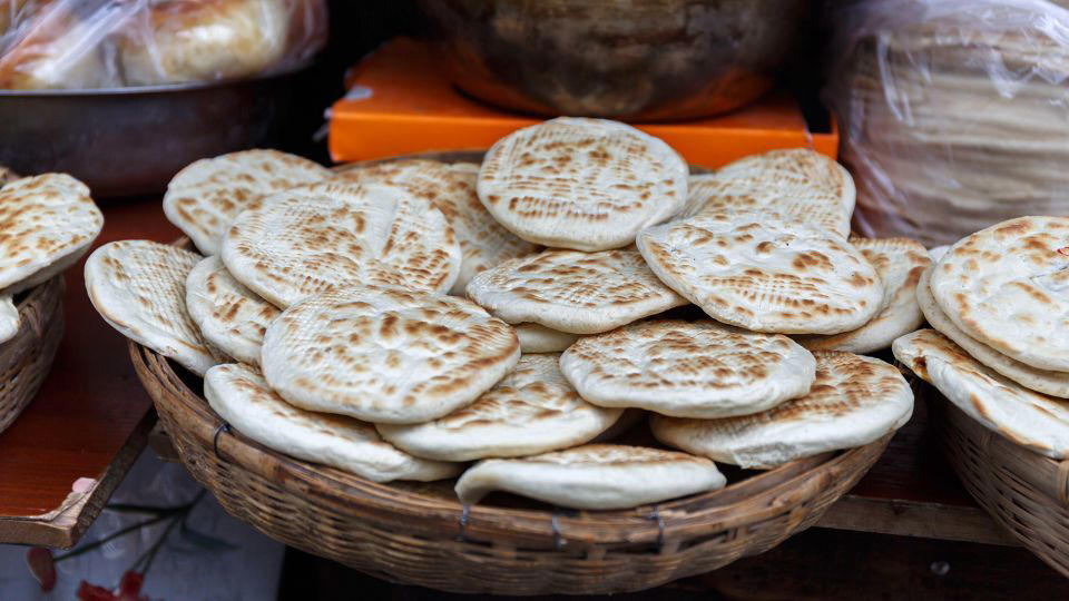 Bolani, Afghanistan, Lavash, Armenia, Damper bread, Australia, Luchi, Bangladesh, Pão de queijo, Brazil, Montreal bagels, Canada, Marraqueta, Chile, Shaobing, China, Pan Cubano, Cuba, Libba, Egypt, Pupusas, El Salvador, Injera, Ethiopia, Baguette, France, Khachapuri, Georgia, Pumpernickel, Germany, Pai bao, Hong Kong, Dökkt rúgbrauð, Iceland, Paratha, India, Roti gambang, Indonesia, Sangak, Iran, Soda bread, Ireland, Challah, Israel, Ciabatta, Italy, Bammy bread, Jamaica, Kare pan, Japan, Taboon bread, Jordan, Roti canai, Malaysia, Ħobż tal-Malti, Malta, Tortillas, Mexico, Khobz kesra, Morocco, Fry bread, Navajo Nation, Tijgerbrood, Netherlands, Rēwena parāoa, New Zealand, Lefse, Norway, Podplomyk, Poland, Broa de milho, Portugal, Karavai, Russia, Pane carasau, Sardinia, Proja, Serbia, Gyeran-ppang, South Korea, Appam, Sri Lanka, Kisra, Sudan and South Sudan, Limpa bread, Sweden, Balep korkun, Tibet, Simit, Turkey, Crumpets, United Kingdom, Biscuits, United States, Non, Uzbekistan, Arepa, Venezuela, Malawach, Yemen