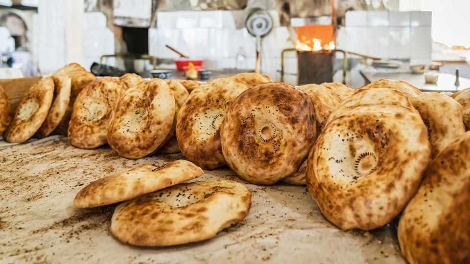 Bolani, Afghanistan, Lavash, Armenia, Damper bread, Australia, Luchi, Bangladesh, Pão de queijo, Brazil, Montreal bagels, Canada, Marraqueta, Chile, Shaobing, China, Pan Cubano, Cuba, Libba, Egypt, Pupusas, El Salvador, Injera, Ethiopia, Baguette, France, Khachapuri, Georgia, Pumpernickel, Germany, Pai bao, Hong Kong, Dökkt rúgbrauð, Iceland, Paratha, India, Roti gambang, Indonesia, Sangak, Iran, Soda bread, Ireland, Challah, Israel, Ciabatta, Italy, Bammy bread, Jamaica, Kare pan, Japan, Taboon bread, Jordan, Roti canai, Malaysia, Ħobż tal-Malti, Malta, Tortillas, Mexico, Khobz kesra, Morocco, Fry bread, Navajo Nation, Tijgerbrood, Netherlands, Rēwena parāoa, New Zealand, Lefse, Norway, Podplomyk, Poland, Broa de milho, Portugal, Karavai, Russia, Pane carasau, Sardinia, Proja, Serbia, Gyeran-ppang, South Korea, Appam, Sri Lanka, Kisra, Sudan and South Sudan, Limpa bread, Sweden, Balep korkun, Tibet, Simit, Turkey, Crumpets, United Kingdom, Biscuits, United States, Non, Uzbekistan, Arepa, Venezuela, Malawach, Yemen