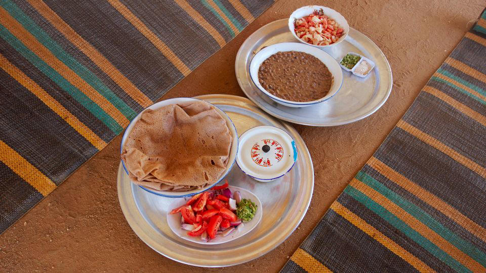 Bolani, Afghanistan, Lavash, Armenia, Damper bread, Australia, Luchi, Bangladesh, Pão de queijo, Brazil, Montreal bagels, Canada, Marraqueta, Chile, Shaobing, China, Pan Cubano, Cuba, Libba, Egypt, Pupusas, El Salvador, Injera, Ethiopia, Baguette, France, Khachapuri, Georgia, Pumpernickel, Germany, Pai bao, Hong Kong, Dökkt rúgbrauð, Iceland, Paratha, India, Roti gambang, Indonesia, Sangak, Iran, Soda bread, Ireland, Challah, Israel, Ciabatta, Italy, Bammy bread, Jamaica, Kare pan, Japan, Taboon bread, Jordan, Roti canai, Malaysia, Ħobż tal-Malti, Malta, Tortillas, Mexico, Khobz kesra, Morocco, Fry bread, Navajo Nation, Tijgerbrood, Netherlands, Rēwena parāoa, New Zealand, Lefse, Norway, Podplomyk, Poland, Broa de milho, Portugal, Karavai, Russia, Pane carasau, Sardinia, Proja, Serbia, Gyeran-ppang, South Korea, Appam, Sri Lanka, Kisra, Sudan and South Sudan, Limpa bread, Sweden, Balep korkun, Tibet, Simit, Turkey, Crumpets, United Kingdom, Biscuits, United States, Non, Uzbekistan, Arepa, Venezuela, Malawach, Yemen
