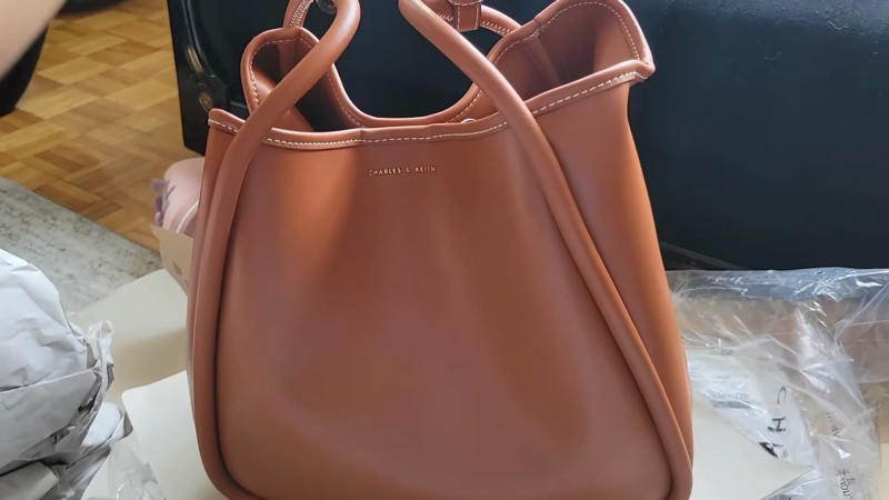 6. Charles & Keith Tote Bag 1. Cuyana System Zipper Tote, 2. MZ Wallace Medium Metro Tote, 3. Telfar Shopping Tote, 4. L.L.Bean Boat And Tote Zip-Top, 5. Kate Spade Nylon Tote, 6. Charles & Keith Tote Bag, 7. Quince Italian Leather Triple Compartment Tote, 8. Calpak Luka Large Tote, 9. Madewell The Essential Bucket Tote, 10. Freja NYC The Tall Tote, 11. Bellroy Tokyo Tote, 12. Sézane Mara Bag, 13. The Row Mesh Market Tote, 14. Kaai Midi Pyramid Tote, 15. Mansur Gavriel Everyday Soft Leather Tote, 16. Bottega Veneta Andiamo Tote, 17. Miu Miu Ivy Leather Tote, 18. Bao Bao Issey Miyake Prism Tote, 19. Aspinal Of London Regent Tote, 20. Tory Burch Perry Bombe