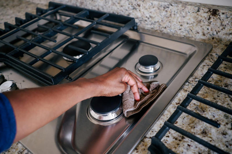 Make the bed (after it airs out), Wipe down the bathroom sink and counter, Wash down shower walls, Disinfect my phone and laptop, Spend a few minutes tidying up, Wipe the kitchen counter, Rinse the kitchen sink, Do a quick vacuum—starting in the kitchen, Clean the stovetop, Wipe kitchen table (or wherever you eat meals), Check inside the fridge