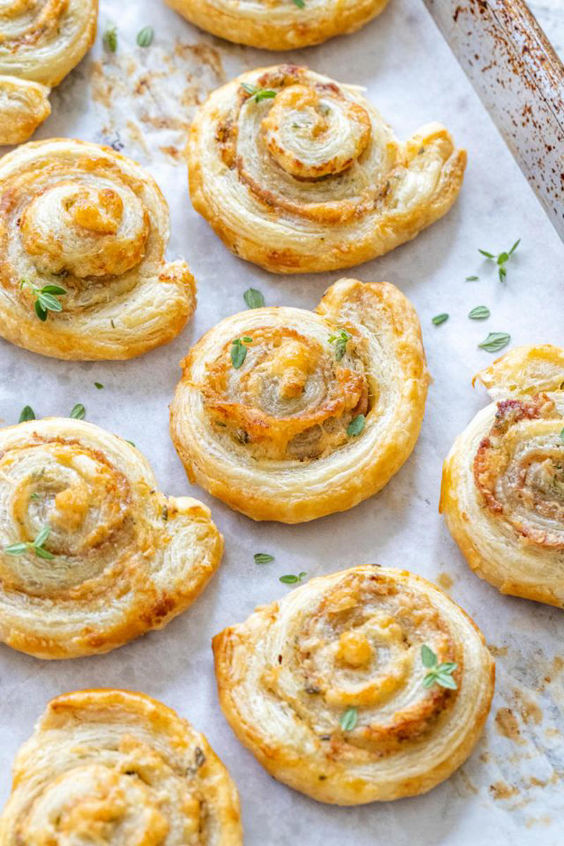 Pea Pesto, Hot Ham and Cheese Sliders, Whipped Feta with Figs, Pistachio, and Honey, Prosciutto and Cheese Puff Pastry Pinwheels, Classic Cheese Ball, Shrimp Cocktail, Creamy Zucchini Dip, Deviled Eggs with Horseradish and Dill, Mini Salmon Quiches, Honey Chorizo Dip, Slow Cooker Glazed Cocktail Meatballs, Easy Baked Brie in Puff Pastry, Smoked Salmon Crostini, Mediterranean Mezze Platter, Classic Stuffed Mushrooms, Million Dollar Deviled Eggs